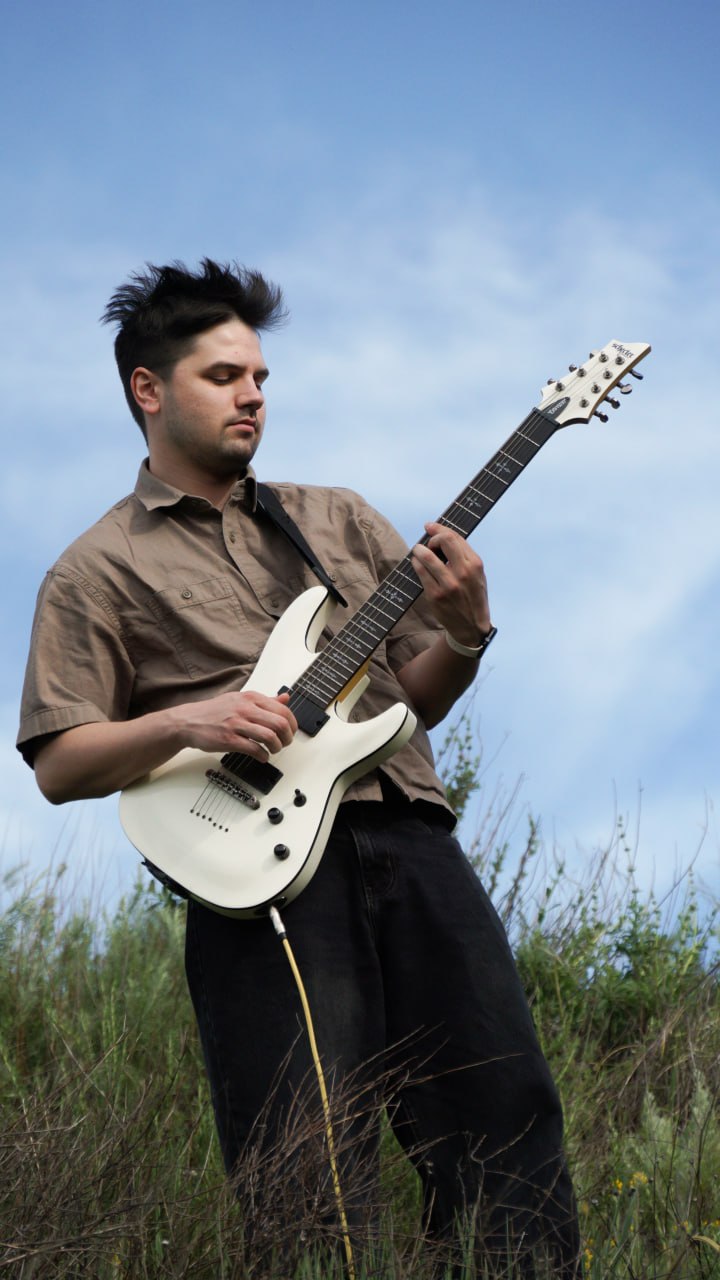 Thaddeus Arndt with electric guitar outdoors in Los Angeles