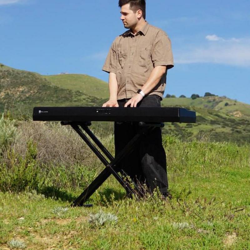 Thaddeus Arndt playing piano outdoors in Los Angeles