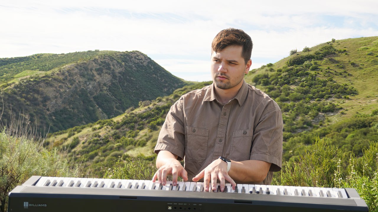Thaddeus Arndt playing keyboard piano outdoors