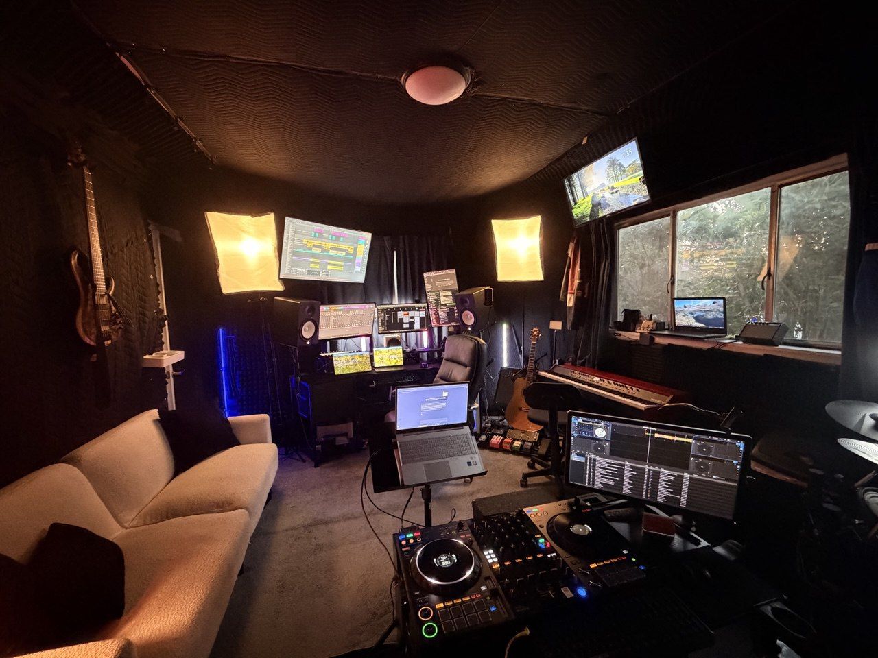 Thaddeus Arndt's music studio in Los Angeles — production desk, multi-monitor DAW setup, DJ controller, and instruments