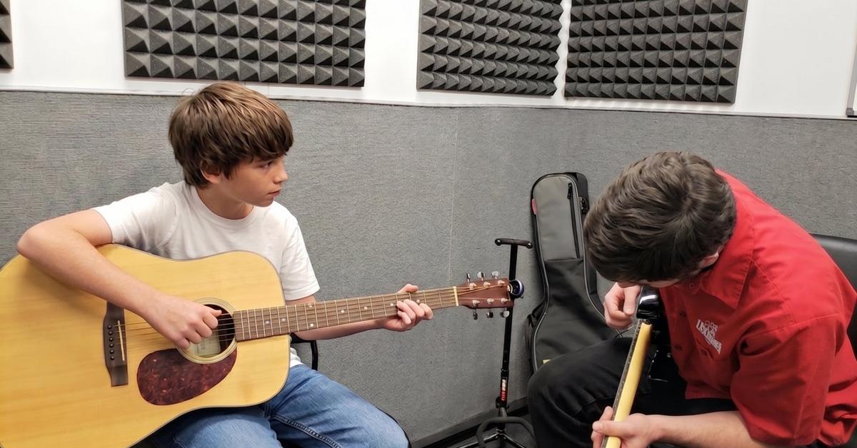 Thaddeus Arndt teaching a guitar student in a lesson room