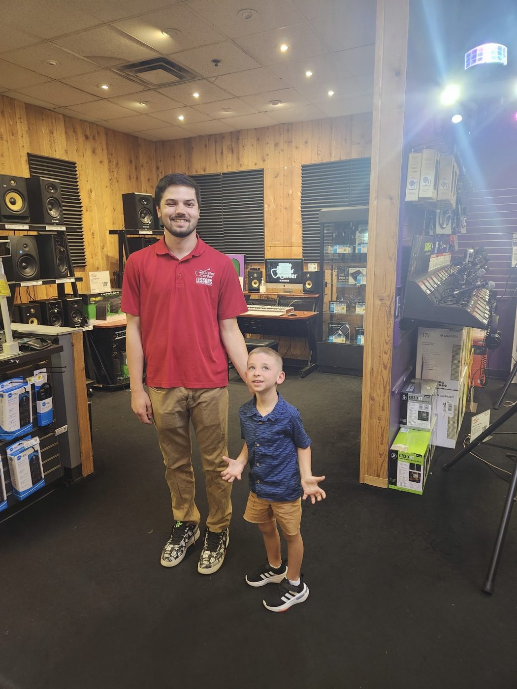 Thaddeus Arndt standing with a young student after his first recital in the lesson studio